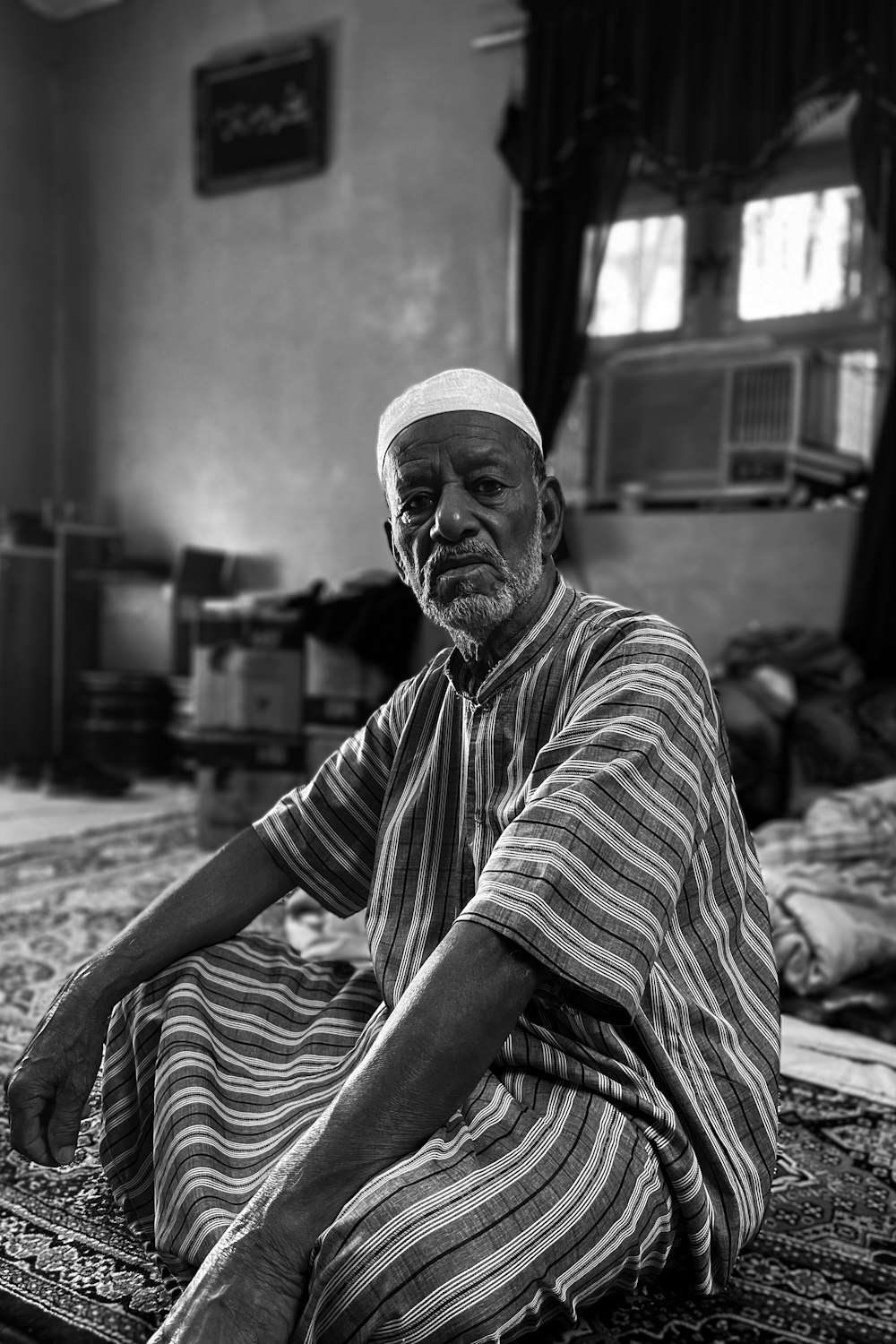 a man sitting on a rug in a room