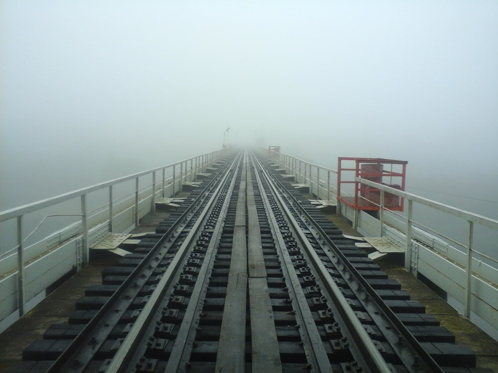 a view of a train track in the fog
