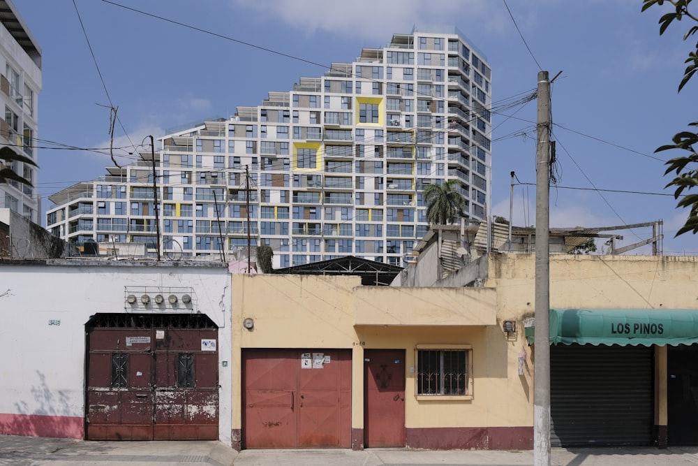 a row of garages sitting next to a tall building