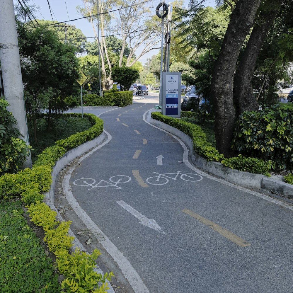 a bike lane with a sign on the side of it