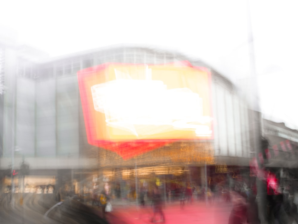 a blurry photo of a building with people walking around