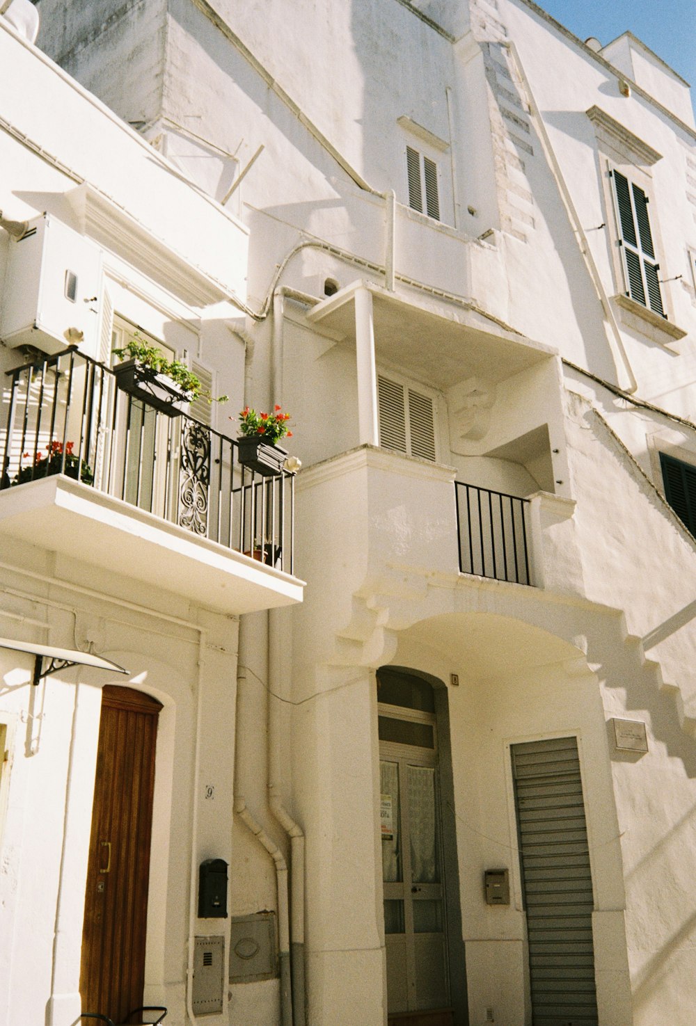 a white building with a balcony and balconies