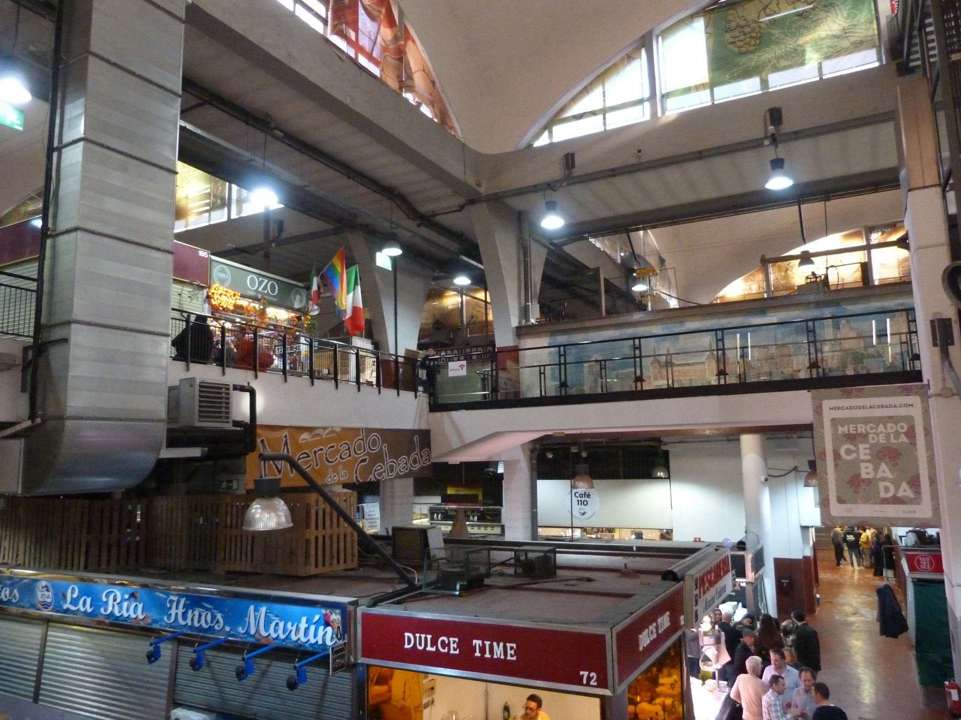 a group of people walking around a shopping mall