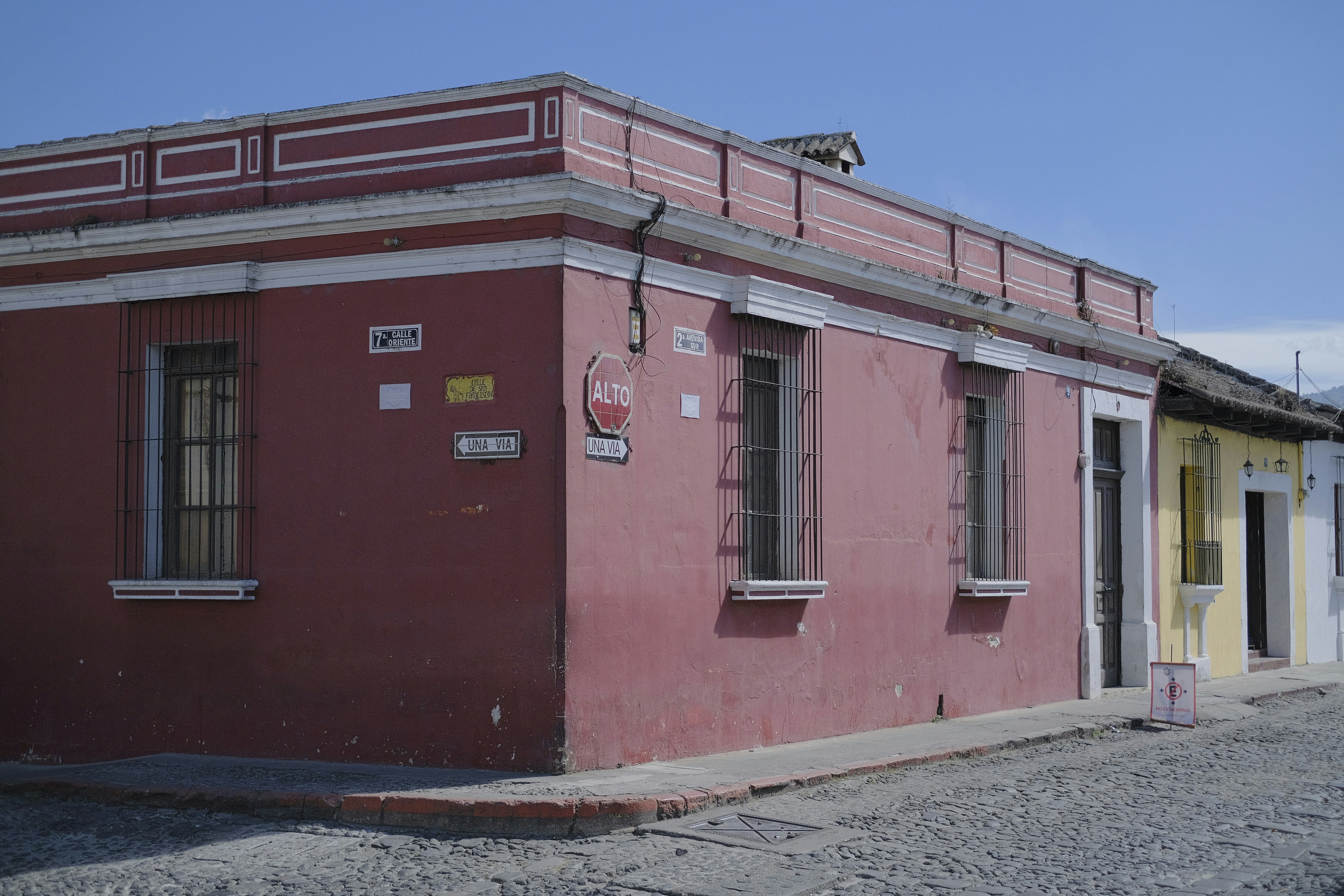 a red building with a yellow door and windows, 