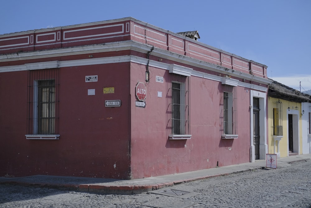 a red building with a yellow door and windows