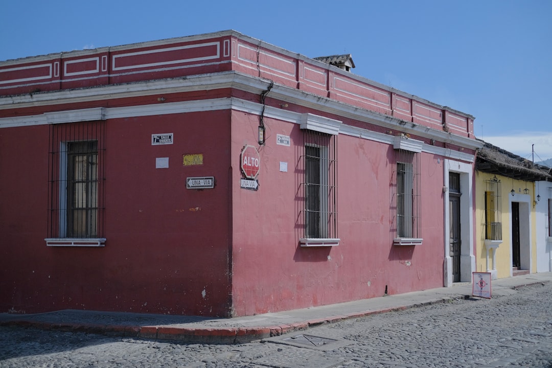 a red building with a yellow door and windows,