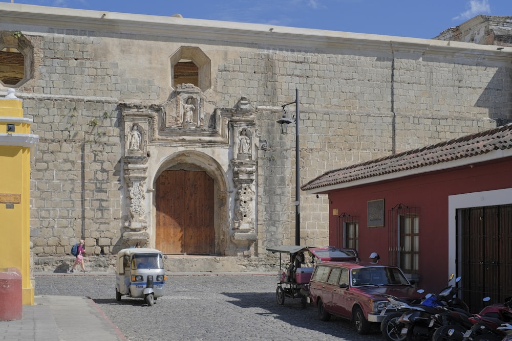 a small car parked in front of a building