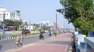a group of people riding motorcycles down a street