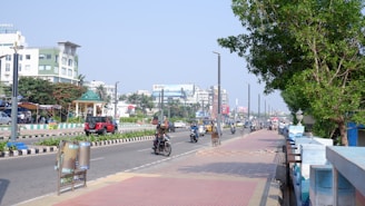 a group of people riding motorcycles down a street