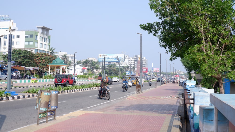 a group of people riding motorcycles down a street