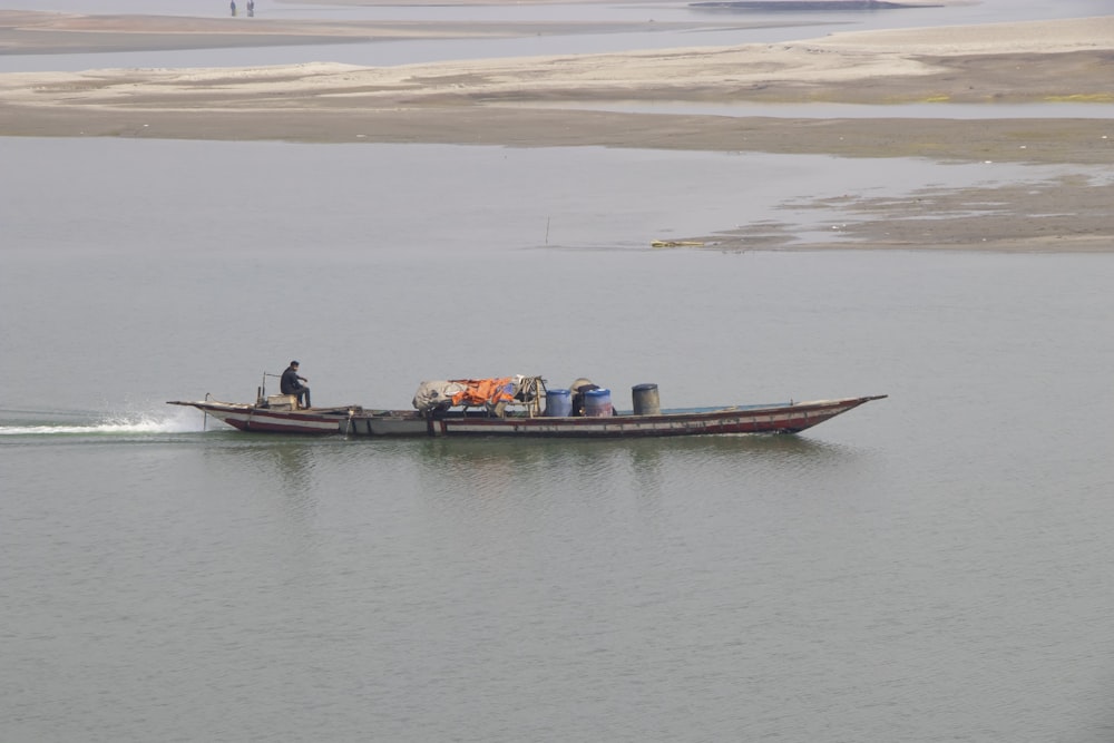 a man on a small boat in the water