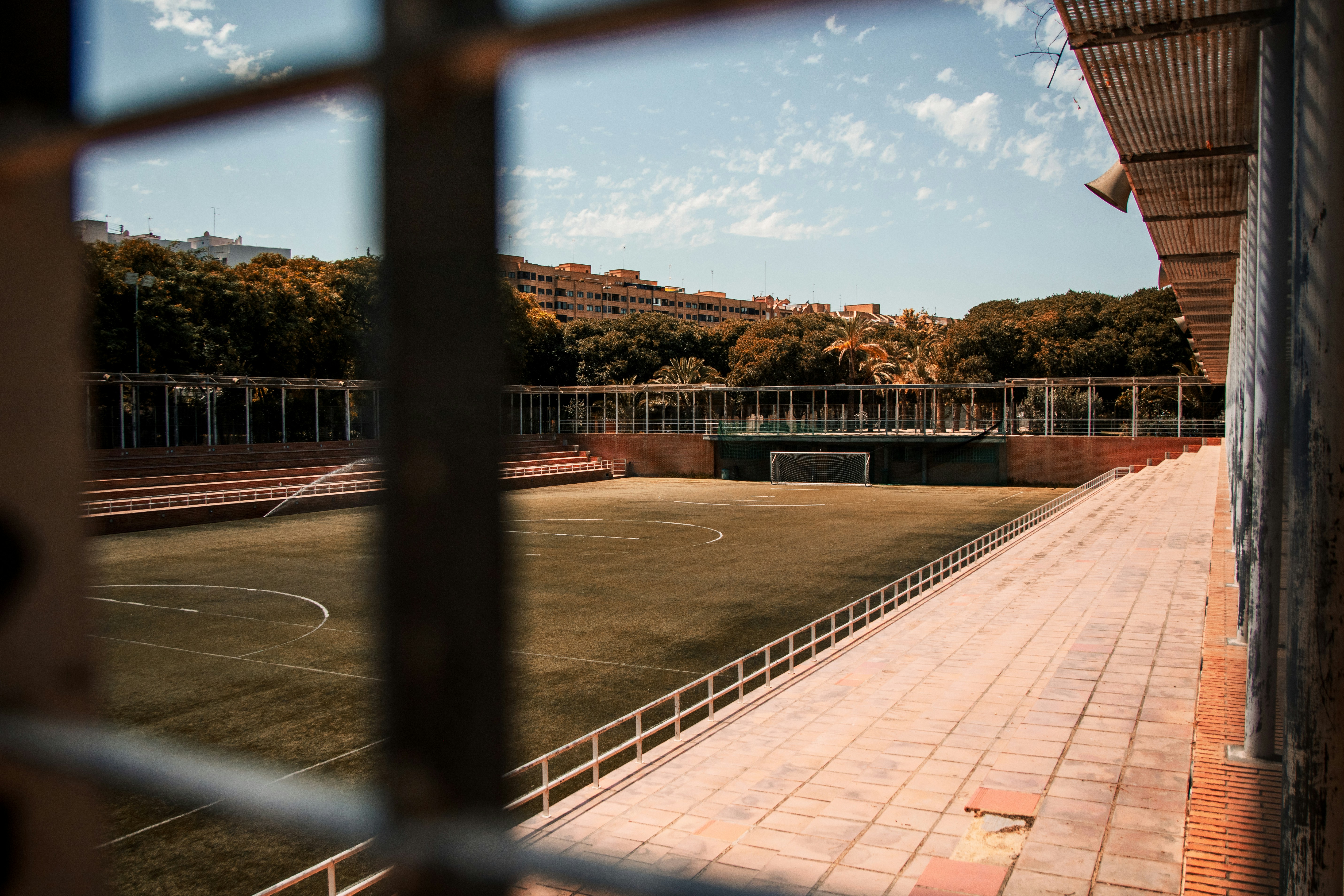a view of a soccer field through a fence