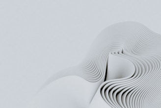a close up of a white object with wavy lines