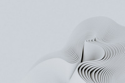 a close up of a white object with wavy lines