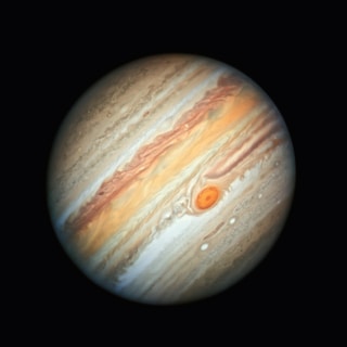 the planet is shown in a dark background