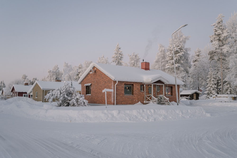a house in the middle of a snow covered road