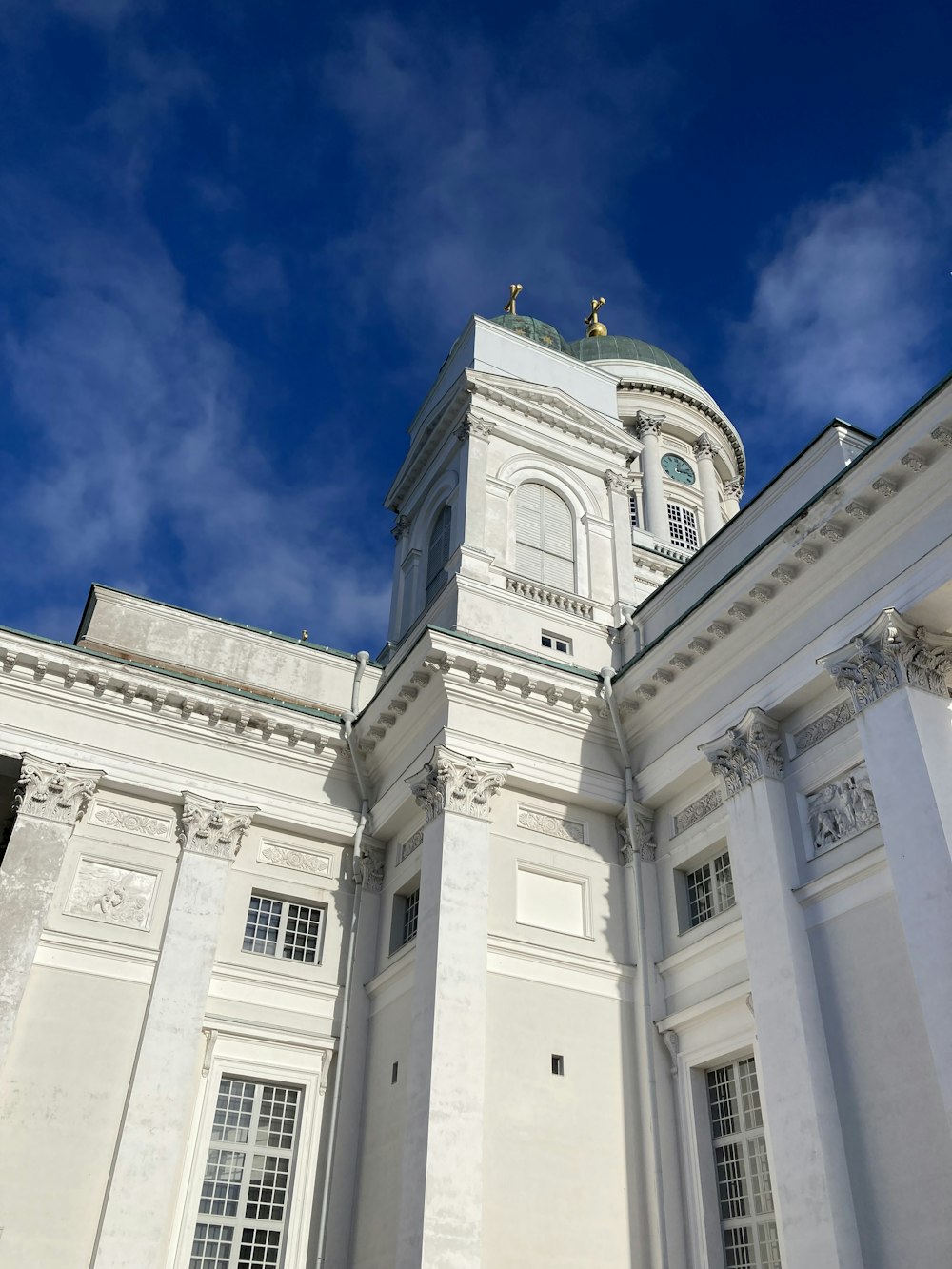 a large white building with a clock tower