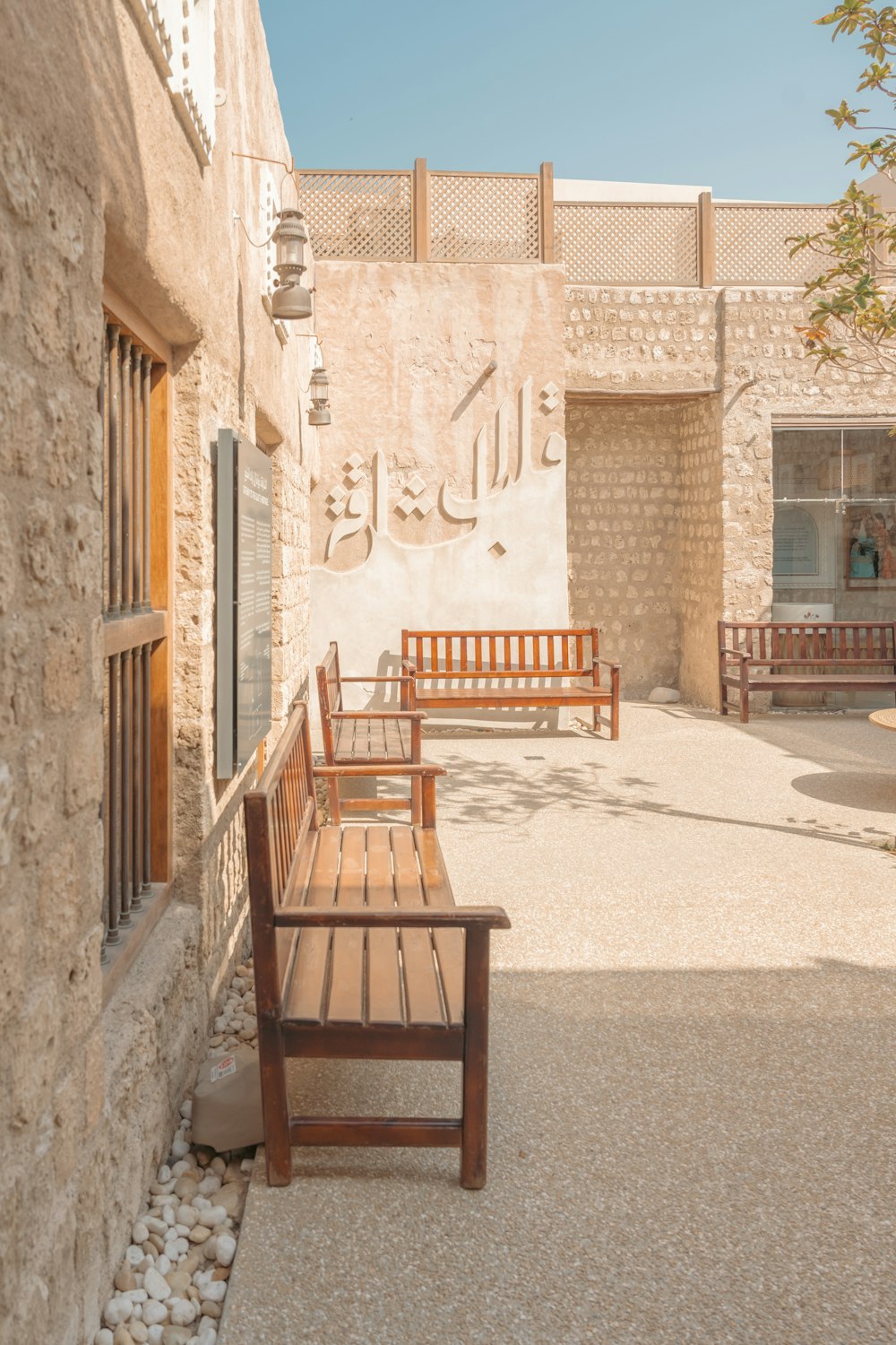 a wooden bench sitting in front of a building