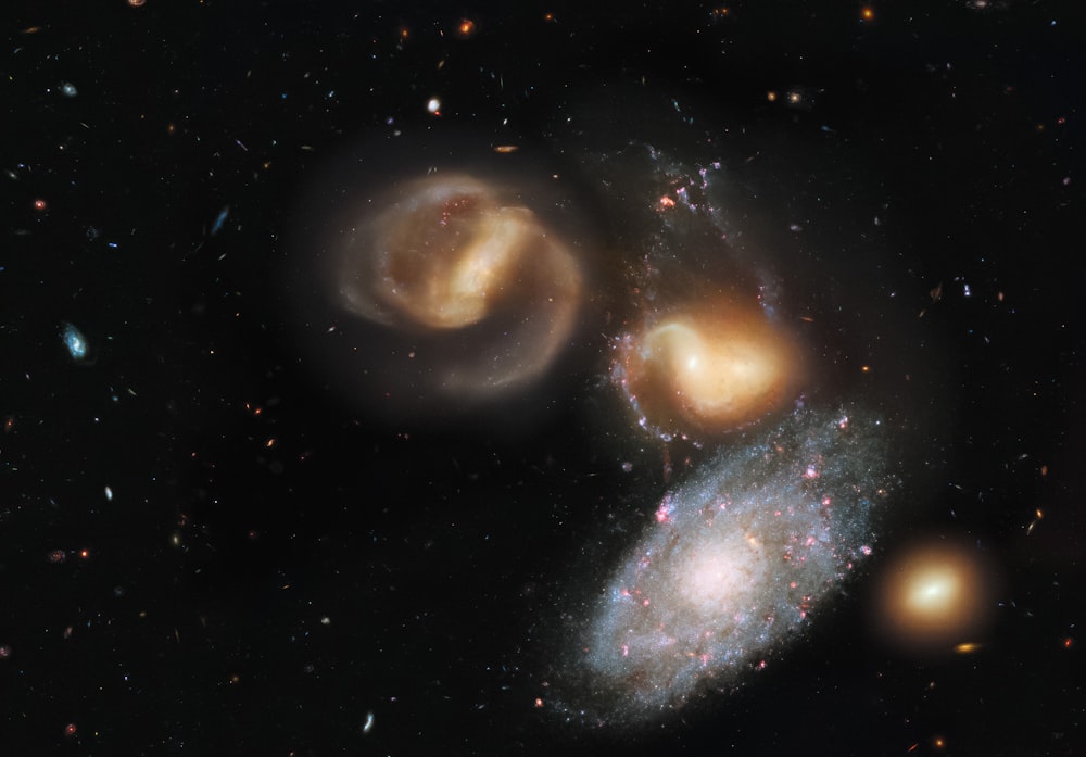 two spiral galaxy like objects in a dark sky