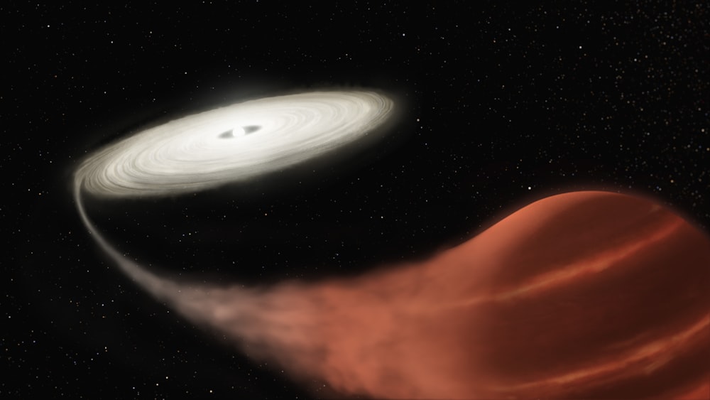 an artist's impression of a black hole and a white disk
