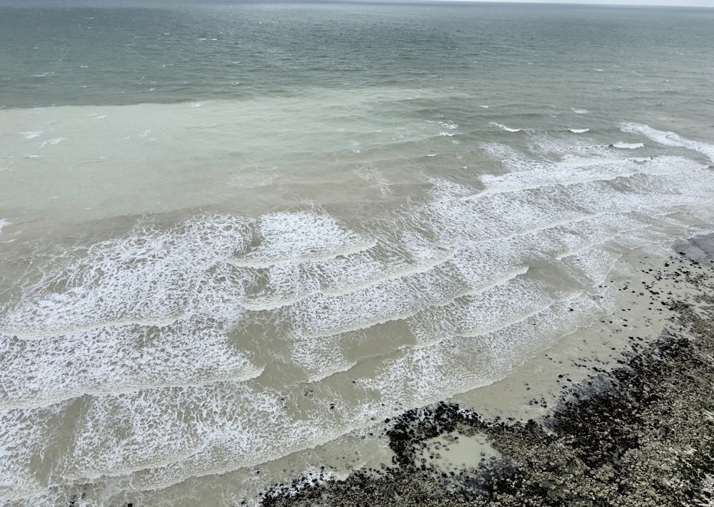 a view of the ocean from the top of a hill