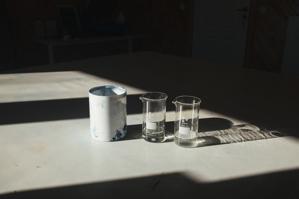 three shot glasses are sitting on a table
