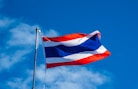 a red, white and blue flag flying in the wind