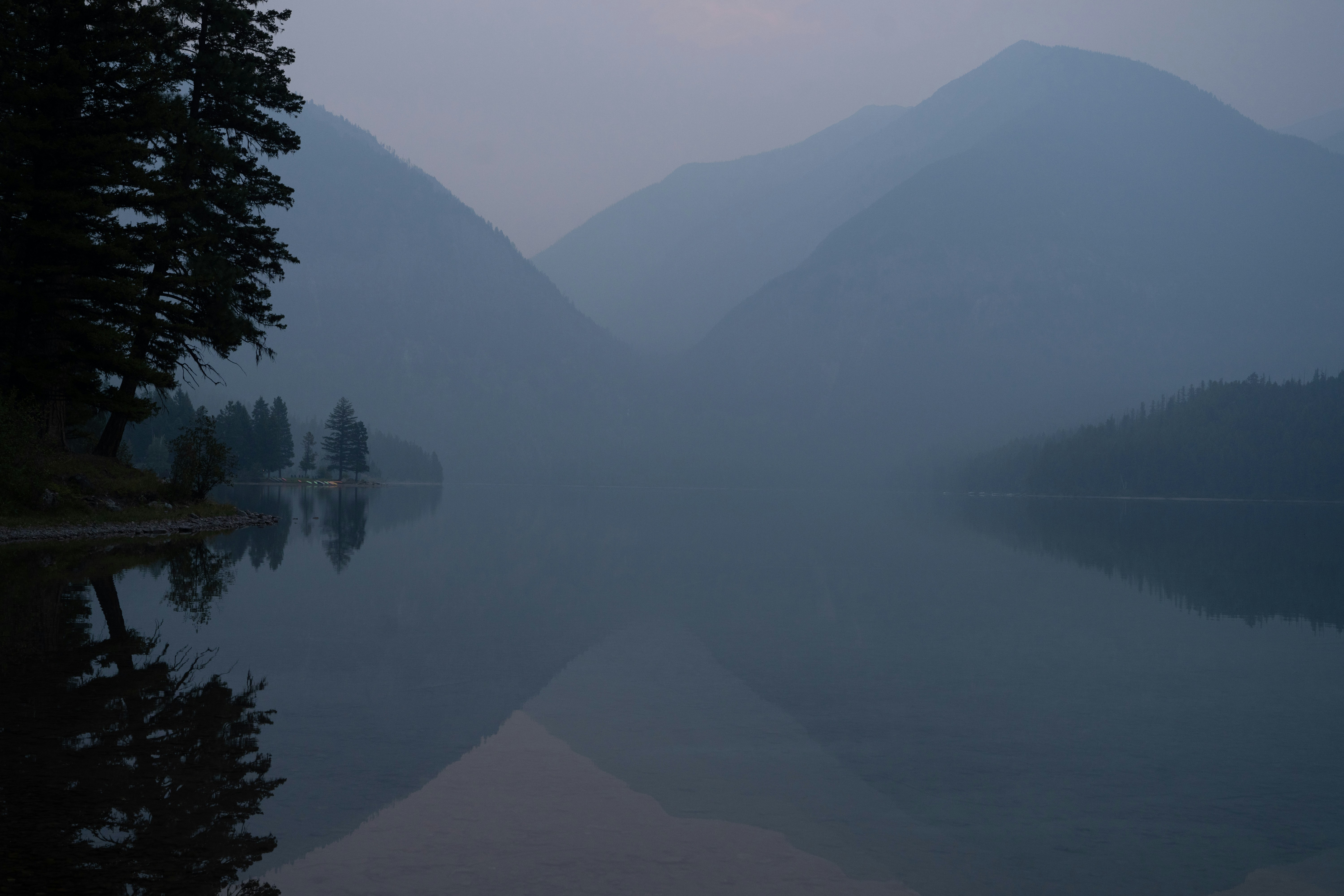 a body of water with mountains in the background