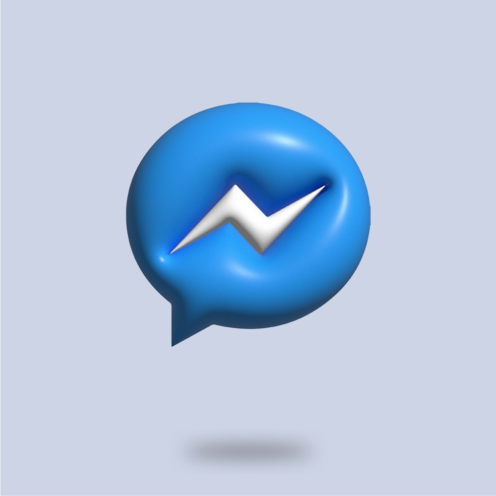 a blue speech bubble with a white m on it
