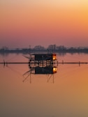 a boat is sitting in the water at sunset