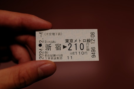 a person holding a ticket in their hand