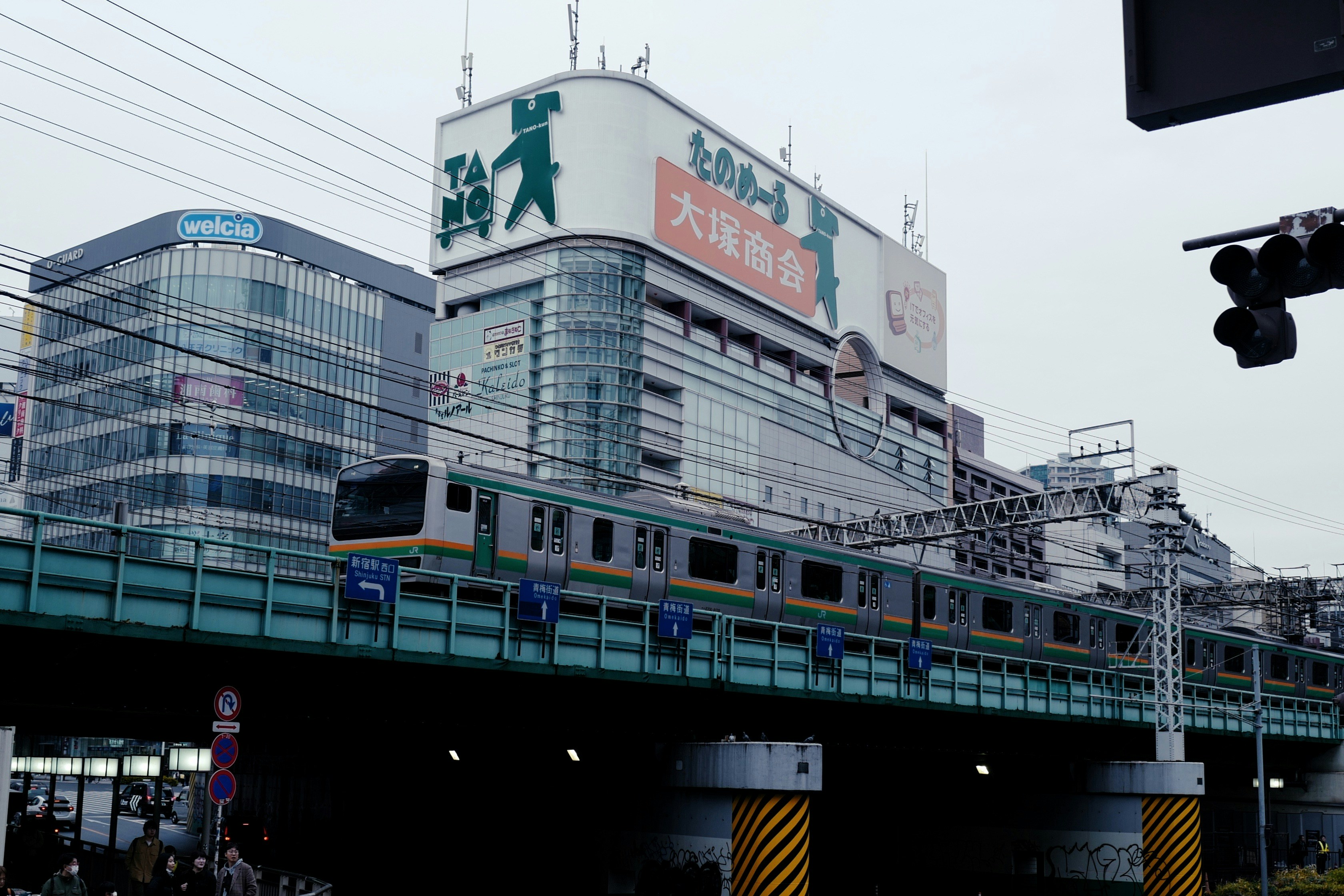 a train traveling over a bridge next to a tall building