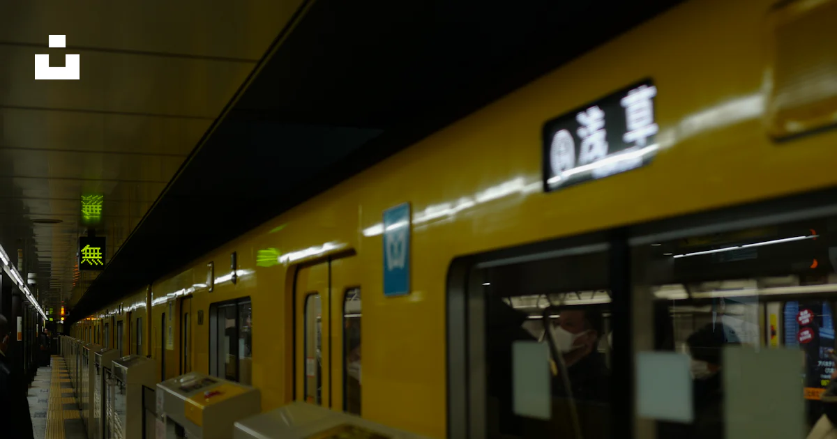 A yellow subway train pulling into a train station photo – Free ...