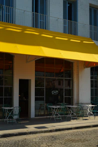 a yellow awning over a restaurant on a city street