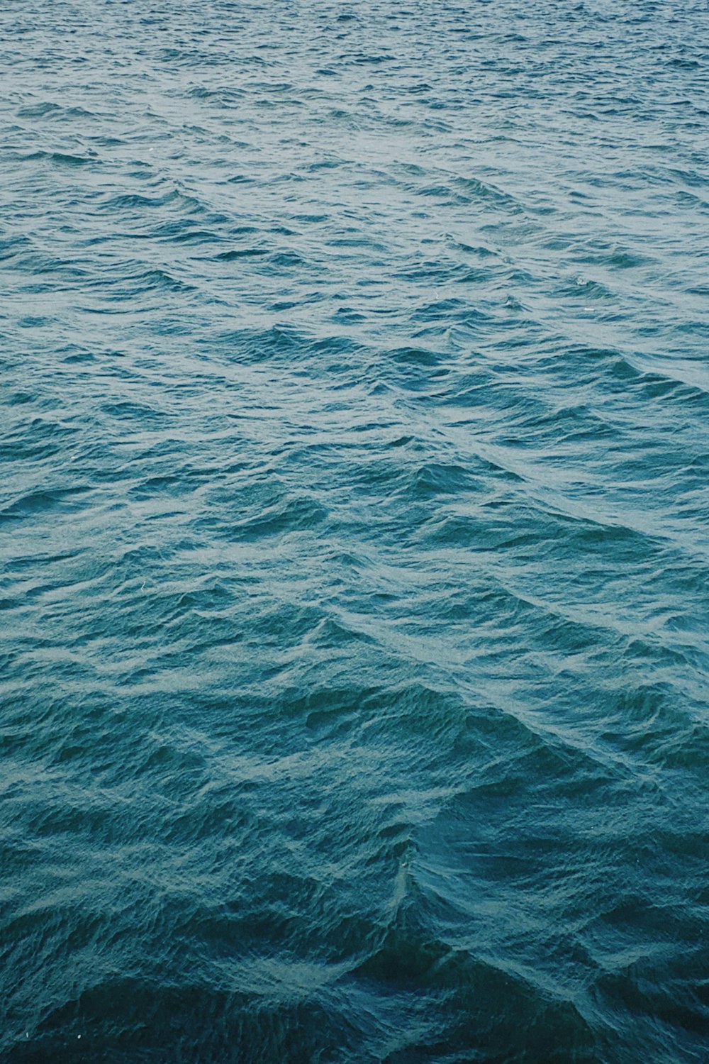 a large body of water with a boat in the distance