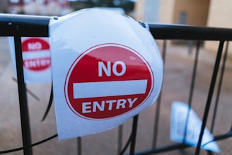 a no entry sign is attached to a gate