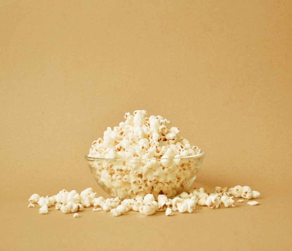 a bowl filled with popcorn sitting on top of a table