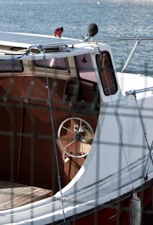 a white and red boat sitting in the water