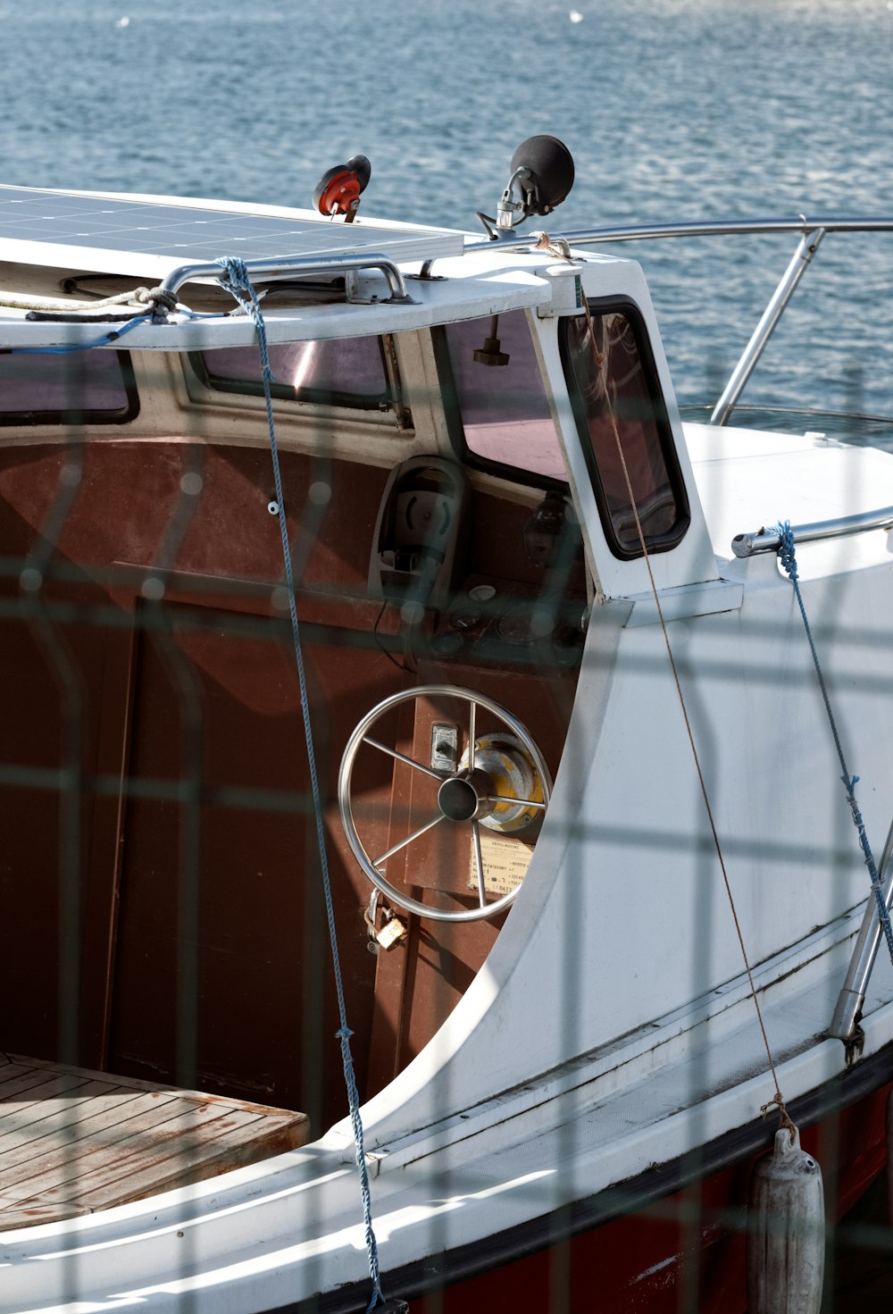 a white and red boat sitting in the water