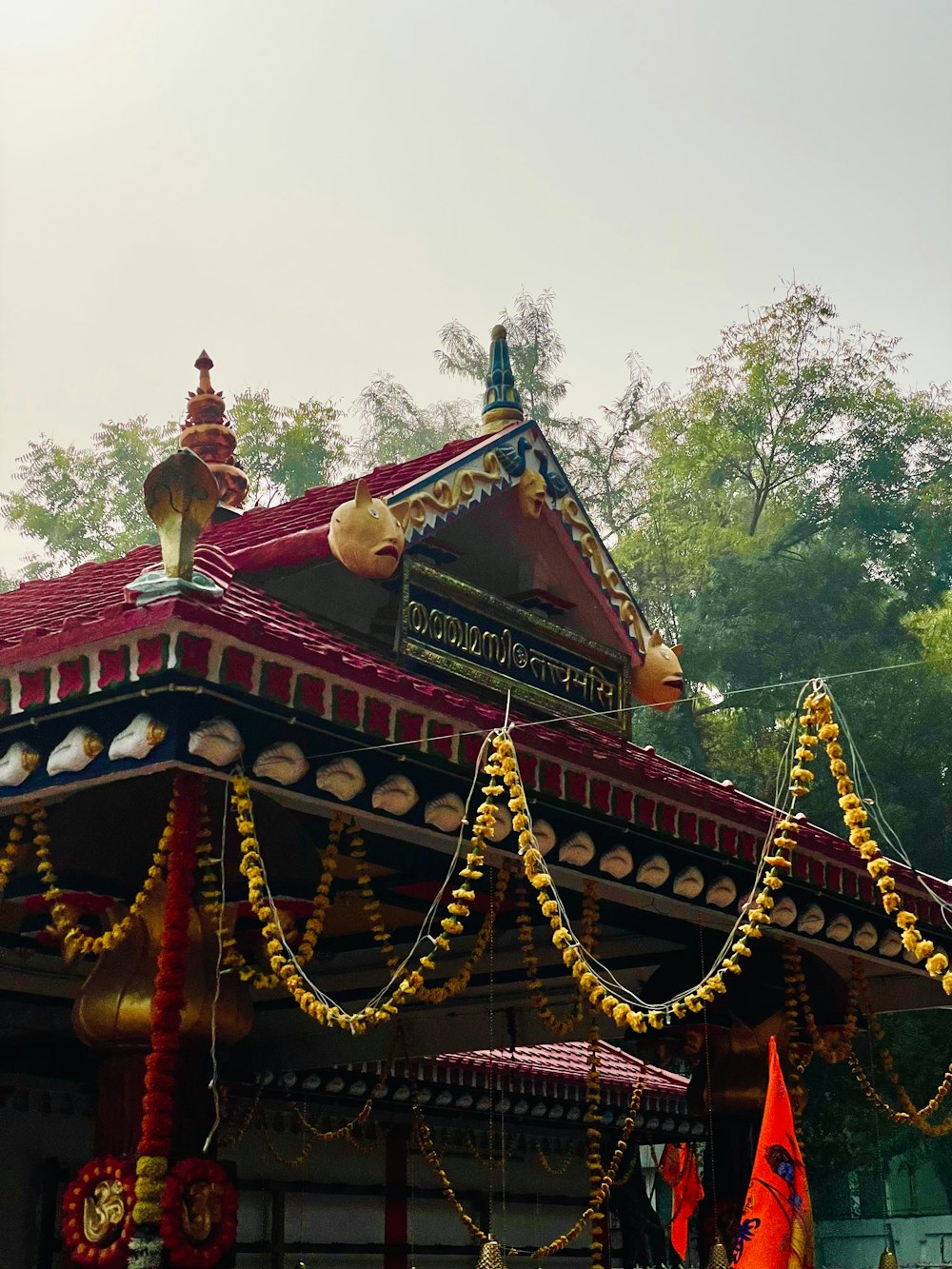 a small building with a red roof and decorations on it