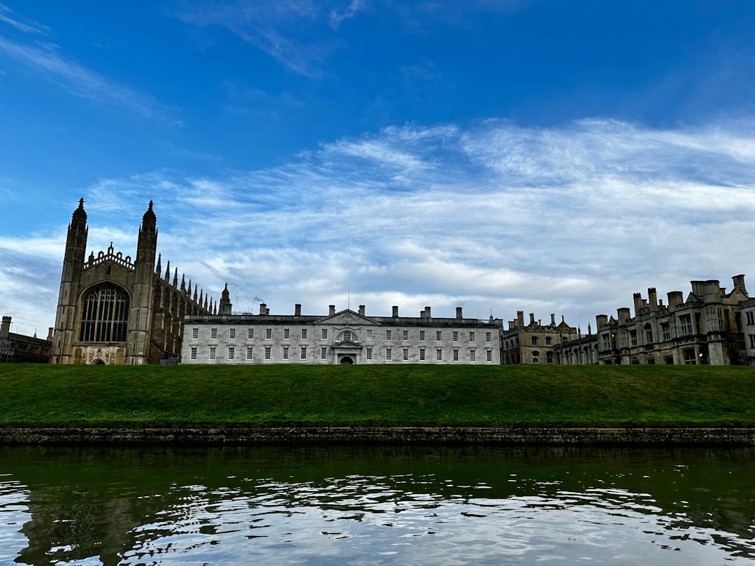 a large building sitting on top of a lush green field,