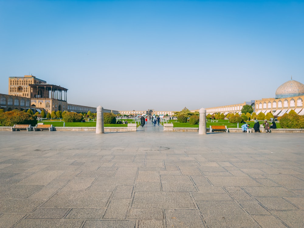 a group of people walking around a large courtyard