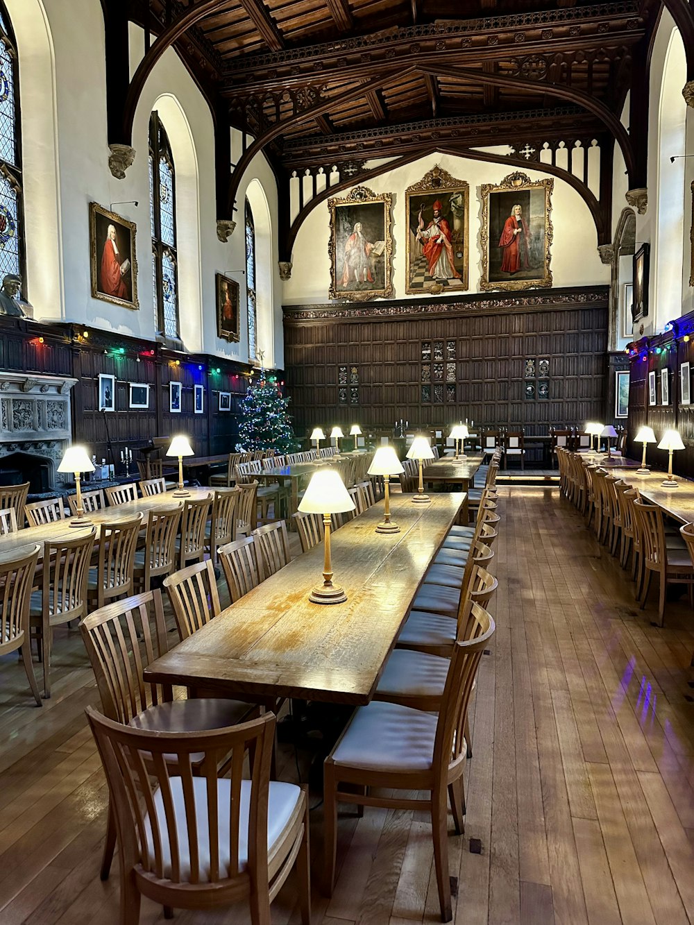 a large dining room with wooden tables and chairs