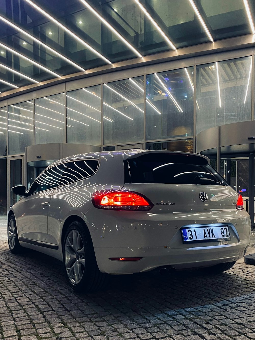 a silver car parked in front of a building