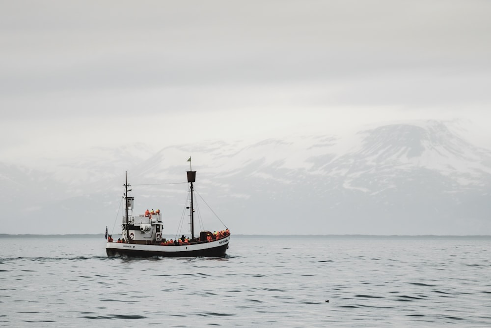 a boat in the water with a mountain in the background