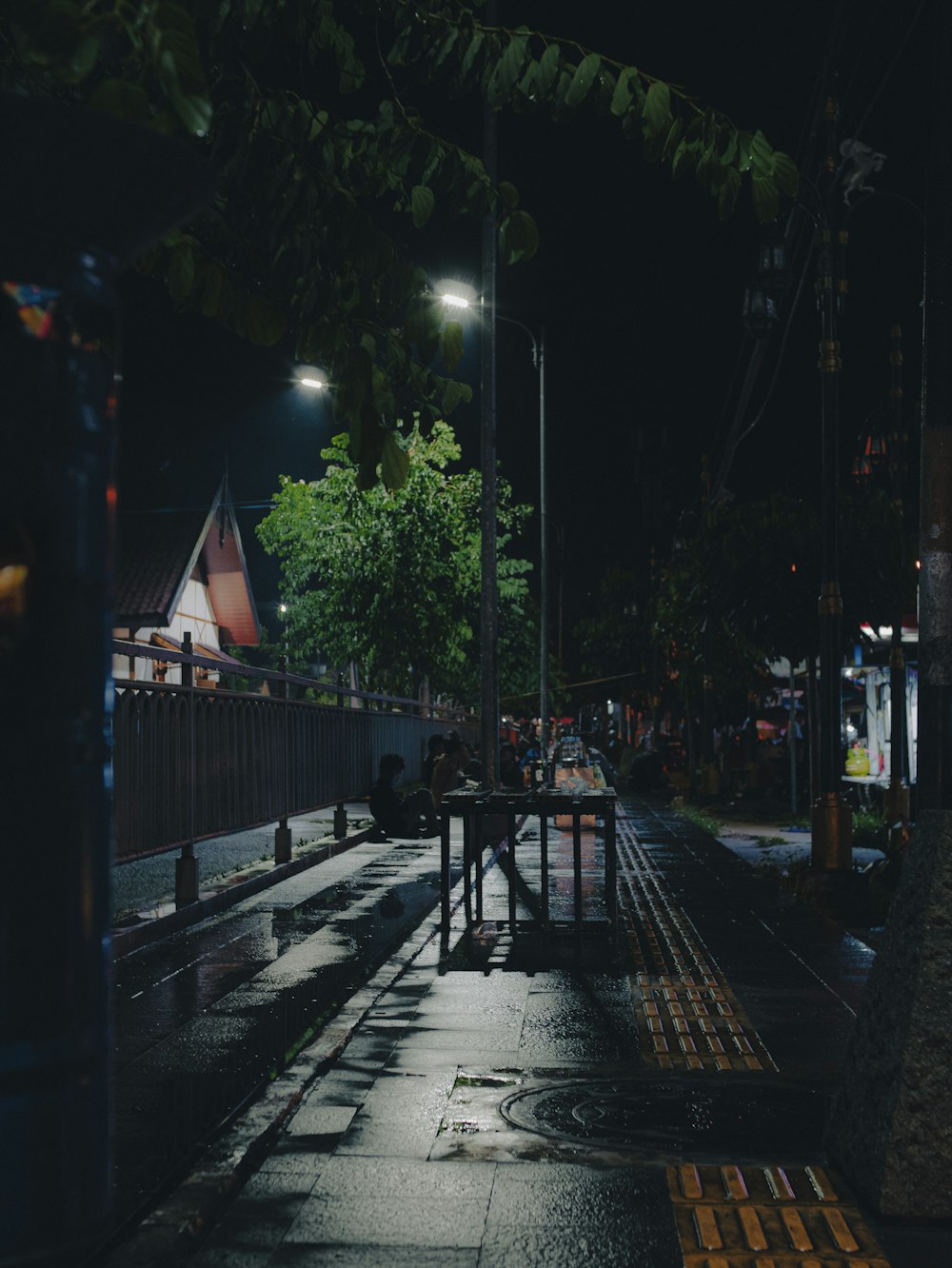 a dark street at night with the lights on