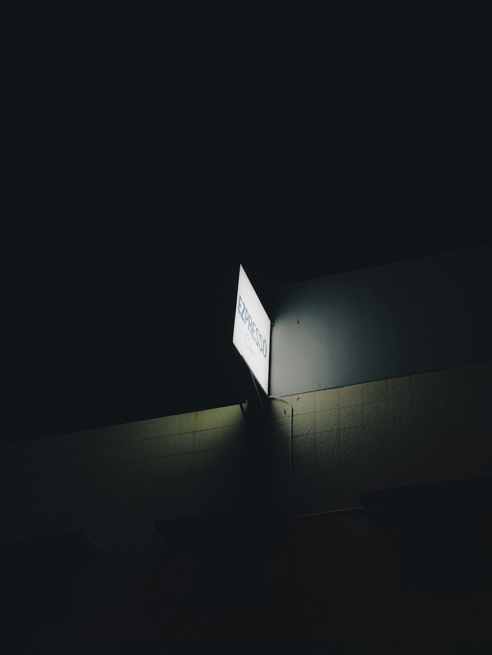 a street sign lit up in the dark