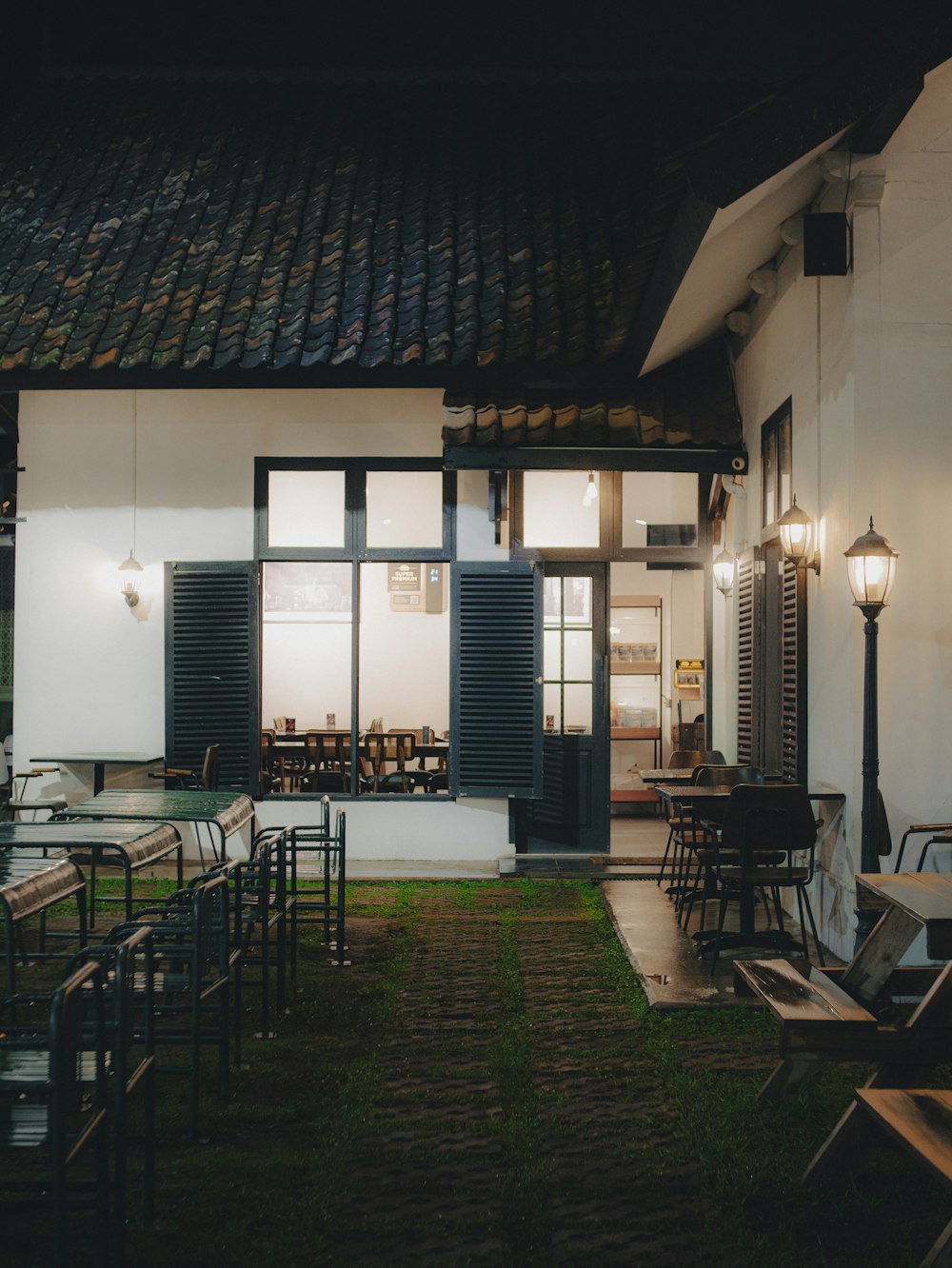 a building with a lawn and tables in front of it