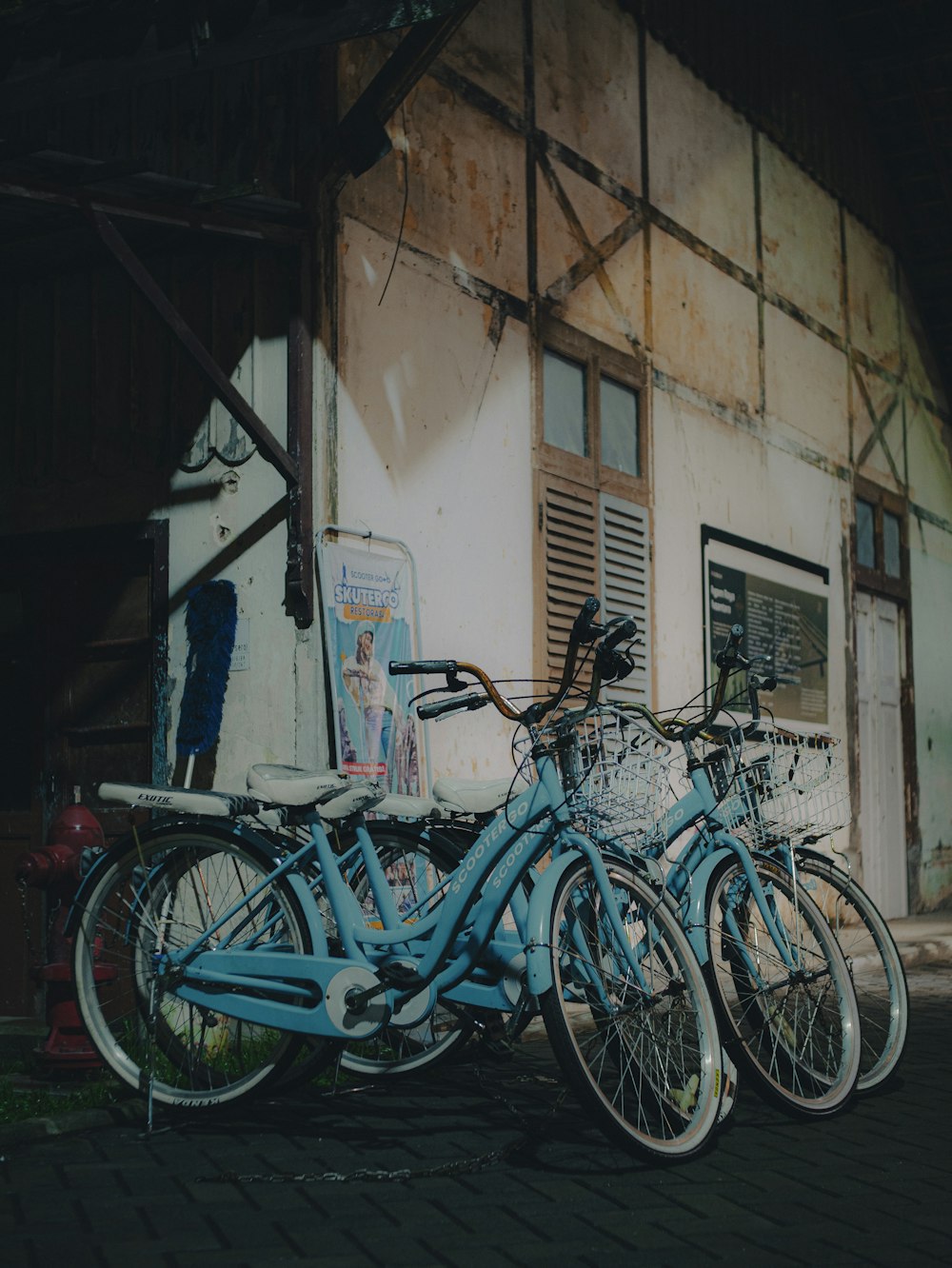 a group of blue bicycles parked next to each other