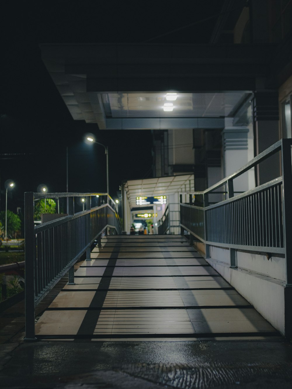 a walkway leading to a building at night